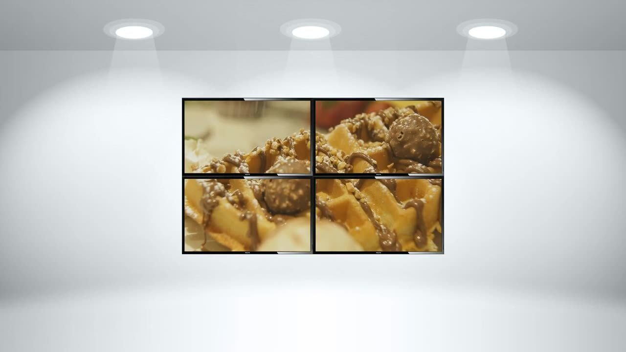Two-by-two digital video wall showing food photography above a counter