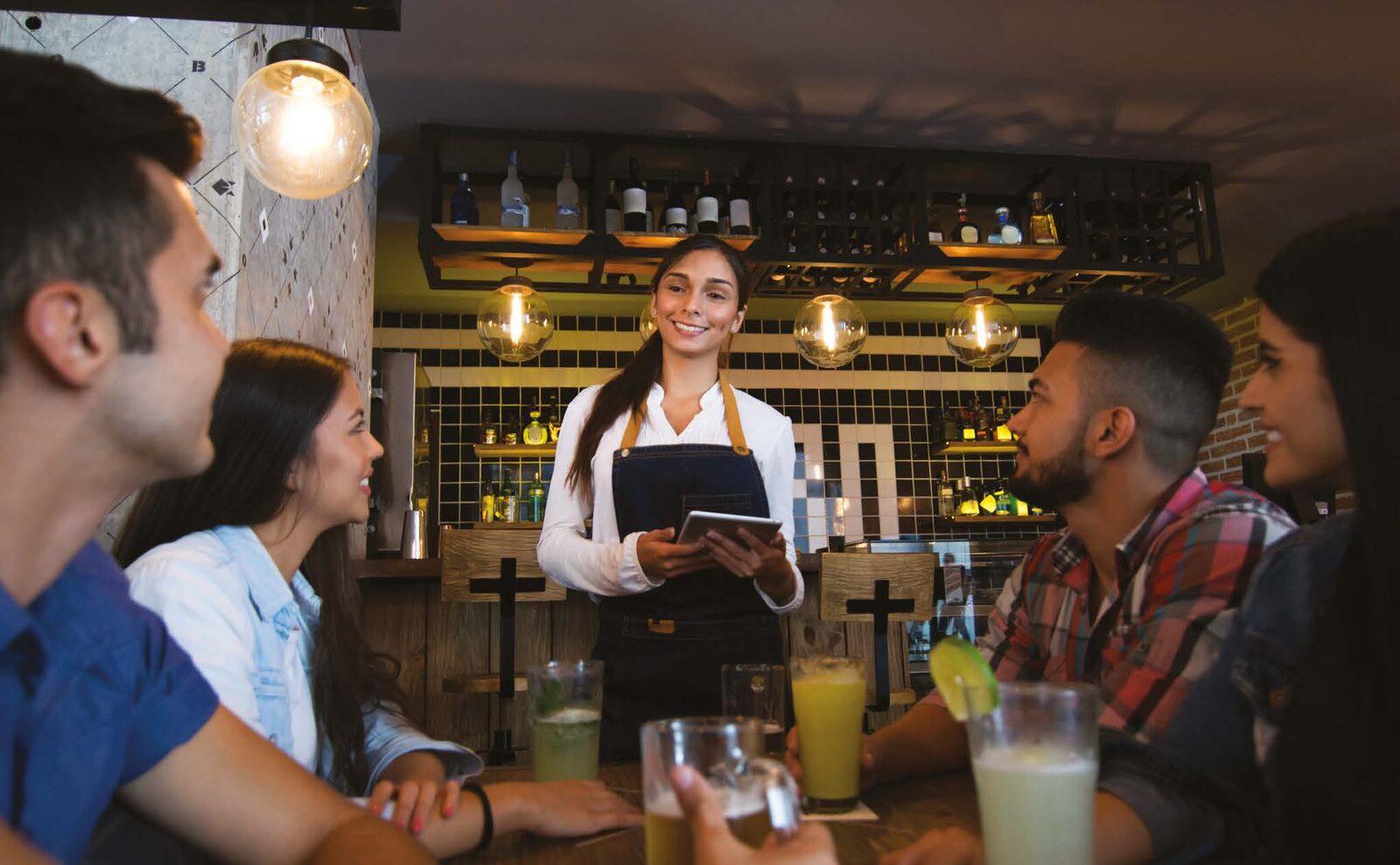 Waiting staff taking an order at the table on a tablet