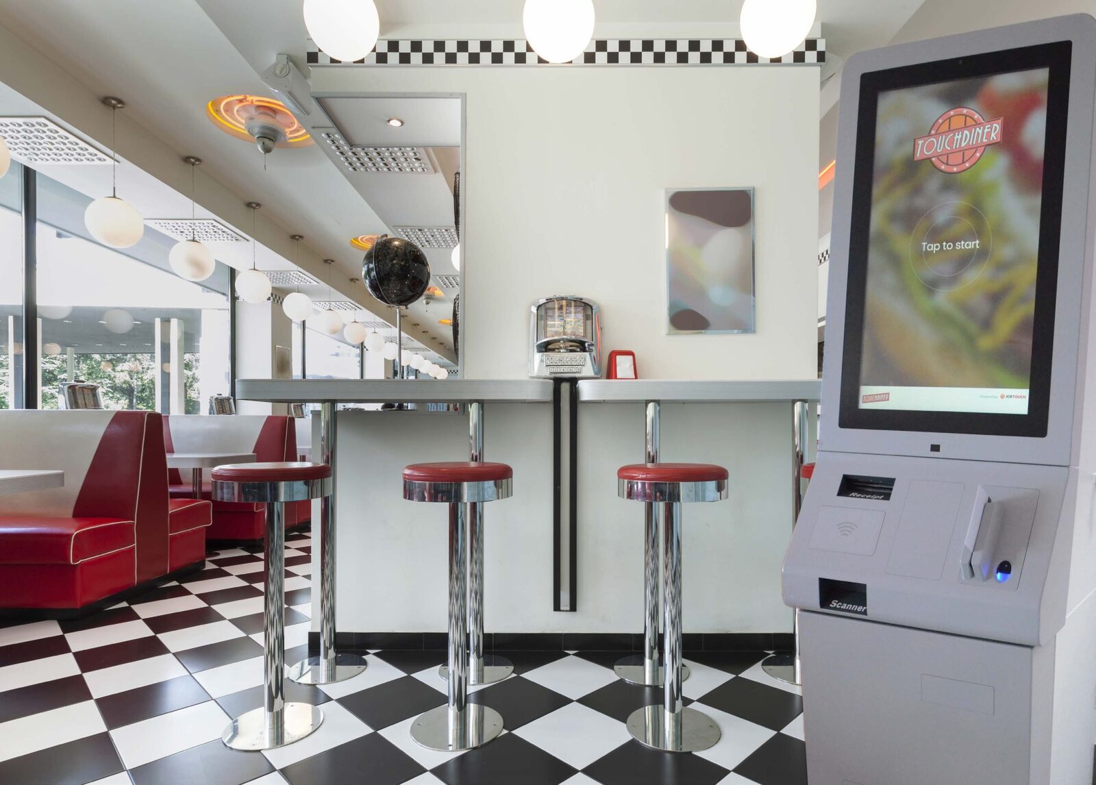 Self-service ordering kiosk beside the counter in a diner