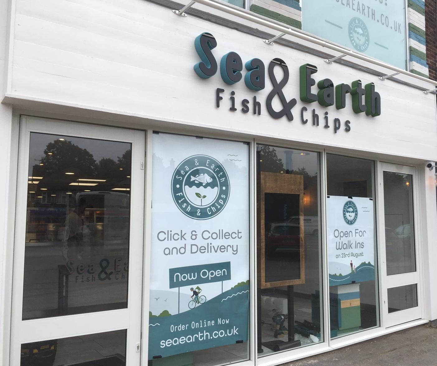 Sea & Earth Fish & Chips shopfront with 3D fascia lettering and window posters showing the website address