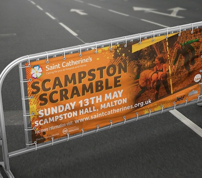 Printed mesh event banner fixed to railings at a country show