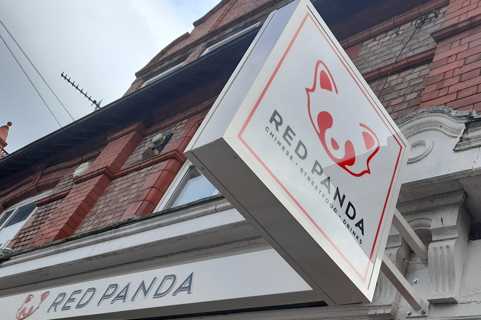 Red Panda projecting shopfront sign